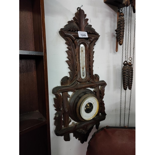 1249 - A wall hanging barometer with elaborate oak frame