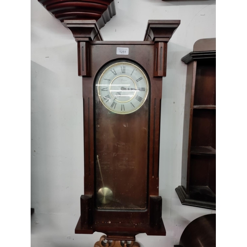 1251 - A mahogany finish wall mounted clock with quartz movement