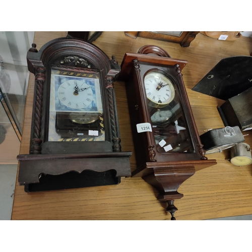 1256 - Two wall mounted clocks, one with key