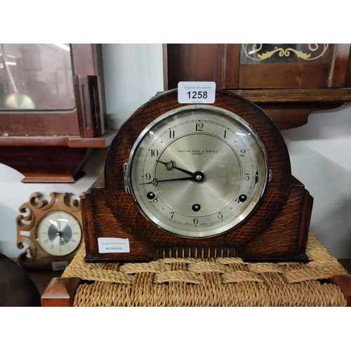 1258 - An oak mantle clock by Darling Wood & Anfield. In working order