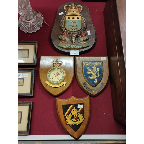 1297 - A collection of four wooden shield plaques