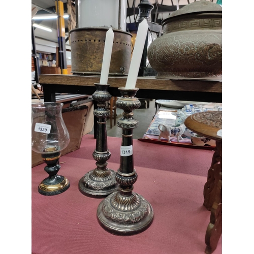 1319 - A pair of silver plate candlesticks with decorative design