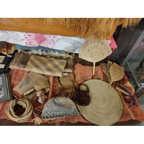 1342 - A large collection of genuine 1920's African grass items including mats, fans, rope and a small bead... 