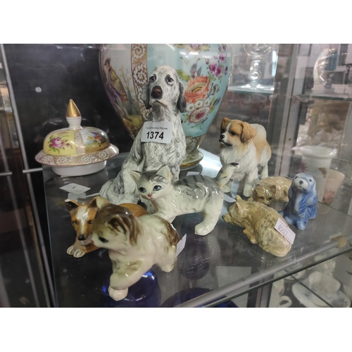 1374 - A collection of ceramic cats and dogs. Eight pieces in total