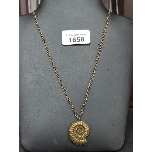 1658 - A brass chain and pendant in the shape of a fossil