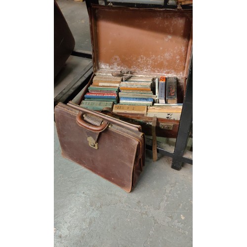 1018 - An old leather suitcase filled with vintage Scout manuals and a leather bag