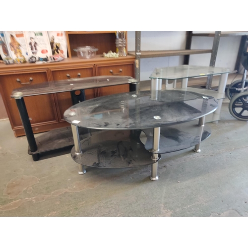 2046 - Two glass TV stands and an oval glass coffee table