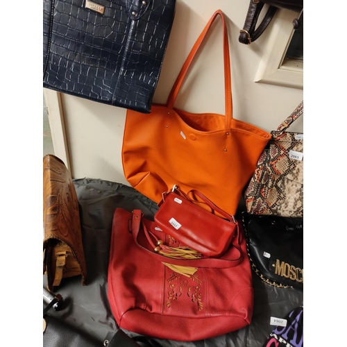 2057 - Two red and one orange handbags