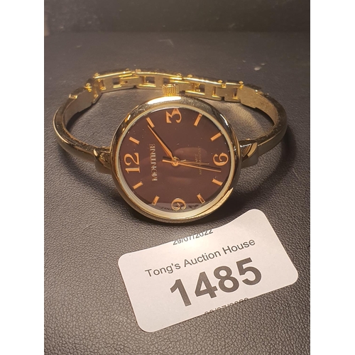 1485 - A gold coloured watch with black face by Montine