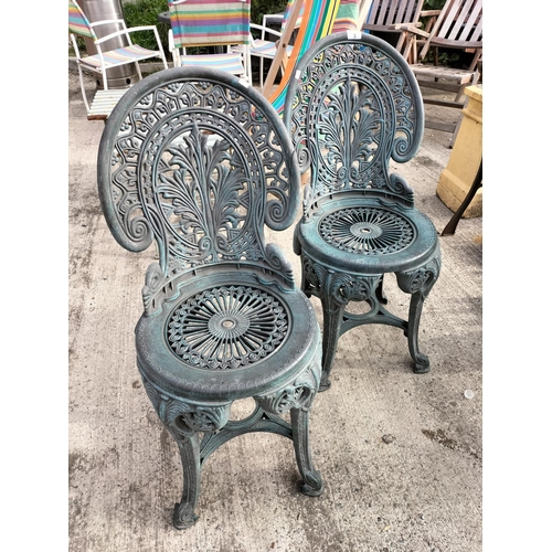 6 - Pair of ornate looking plastic outdoor chairs