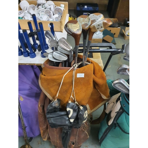 233 - A collection of vintage Garidge Triple Crown Bobby locke golf clubs in leather vintage bag