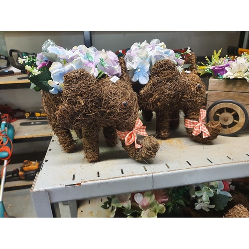 308 - TWO ELEPHANT PLANTERS WITH ARTIFICIAL FLOWERS