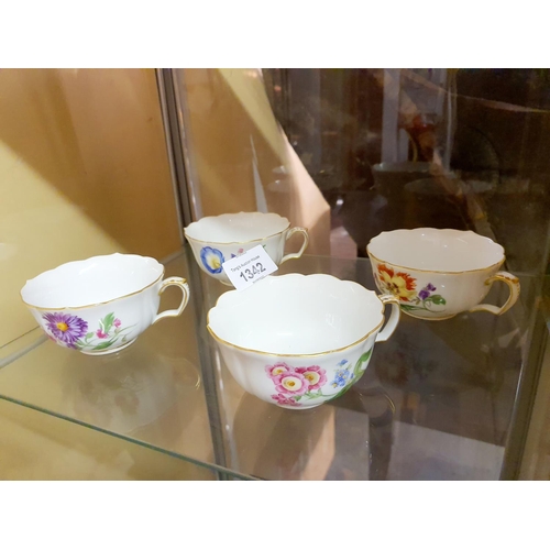 1342 - Four Meissen porcelain tea cups marked with the 1710 - 1935. One cup has small chip to rim, the othe... 