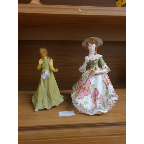 687 - Two figurines of ladies. One is musical