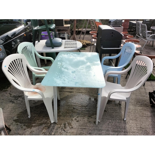 8 - Sturdy metal and glass top outdoor table with 4 pastel coloured plastic chairs