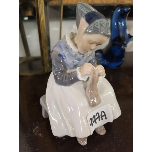 997A - A small Royal Copenhagen Denmark figure of a lady sewing. Approx 15cm tall.