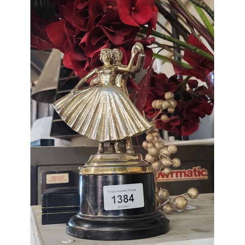 1384 - **LAST CHANCE ITEM** A brass ballroom trophy on Bakelite plinth.