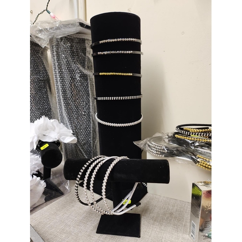 1611 - Two black velvet display stands and a collection of headbands