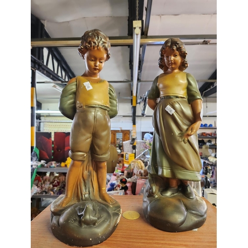 831 - A large pair of vintage plaster figures of a boy and a girl