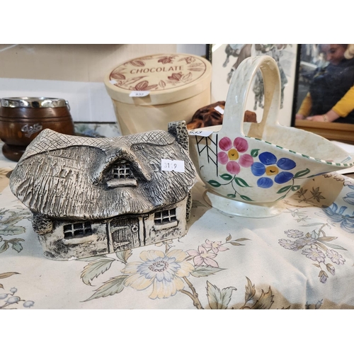 933 - A Tuscan Decco pottery basket shaped vase and a plaster model of a cottage