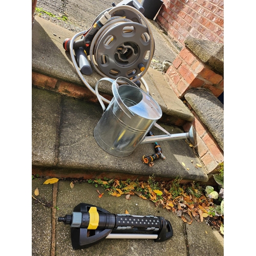 39 - Hose pipe on reel Galvanised watering can and lawn sprinkler