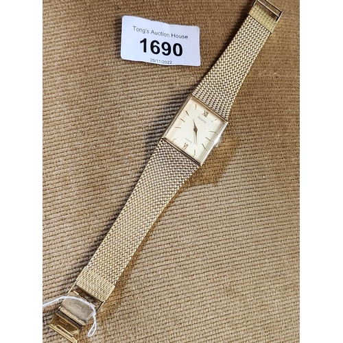 1690 - A men's gold tone Accurist watch with rectangle face. new battery