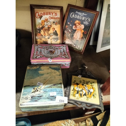 686 - Two framed vintage Cadburys advertising prints, two vintage tins and a vintage tile