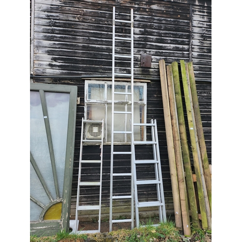 74 - three aluminium extending ladders