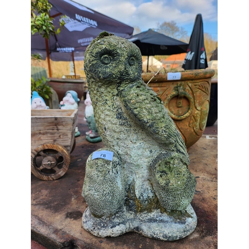 78 - A concrete garden ornament of an owl with young owlets 36cm tall.