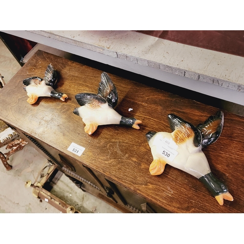 530 - A set of three wall hanging pottery ducks.