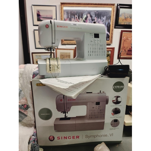 599 - A Singer Symphonie V1 electric sewing machine in original box with instruction manual.