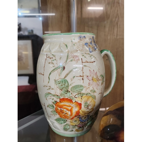 953 - A large Arthur Wood ceramic jug with hand painted floral design 19cm tall