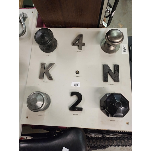 380 - Display board of large door knobs and letters