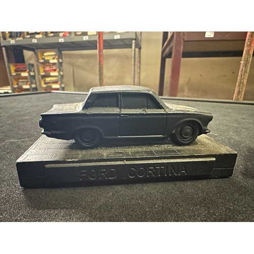 27 - Two model car figures made from coal including Ford Cortina and MGB GT