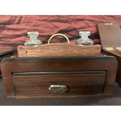523 - Wooden writing inkwell set with brass detailing, two ink bottles and drawer