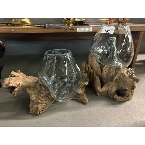597 - Two stylish molten glass vases on drift wood