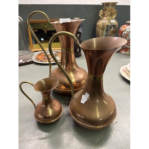 609 - Set of three copper and brass jugs