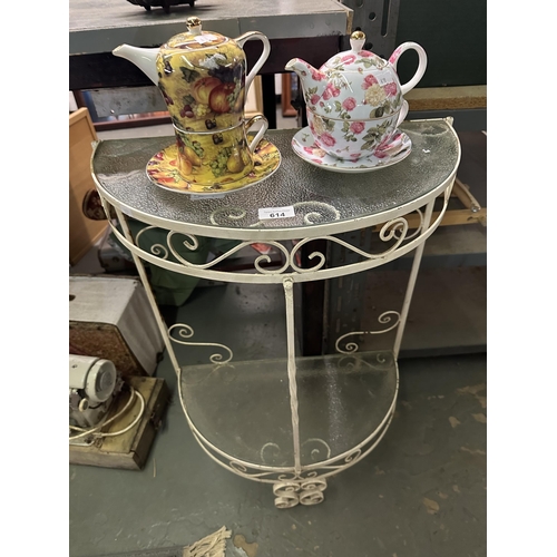 614 - Glass topped half moon side table and two teapot and cup sets