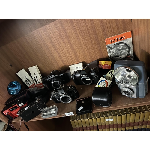 663 - Collection of photography equipment including Nikon cameras, atlas photoflash, Toshiba filter and Br... 