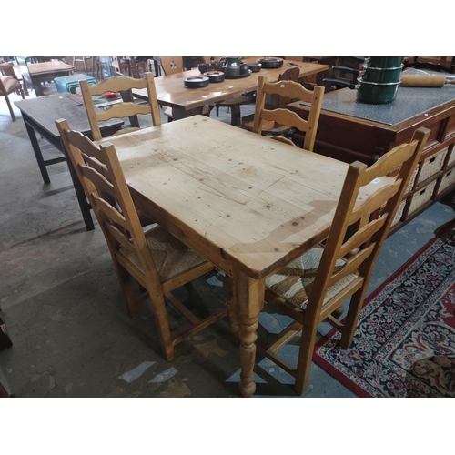 1388 - Great sized solid pine table with 4 chairs with rattan seats.
120 x 75cm