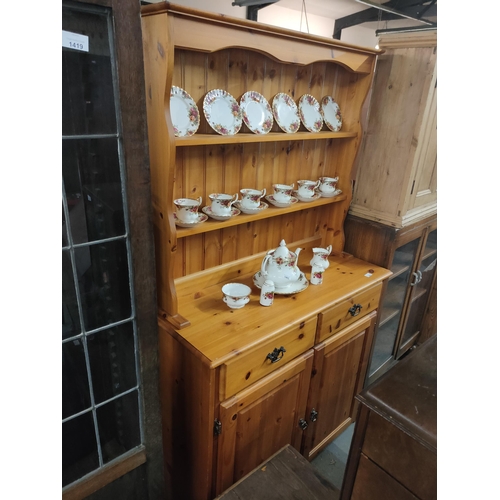 1402 - Solid pine kitchen dresser with cupboard, drawers and shelving.
108w x 84h cm.