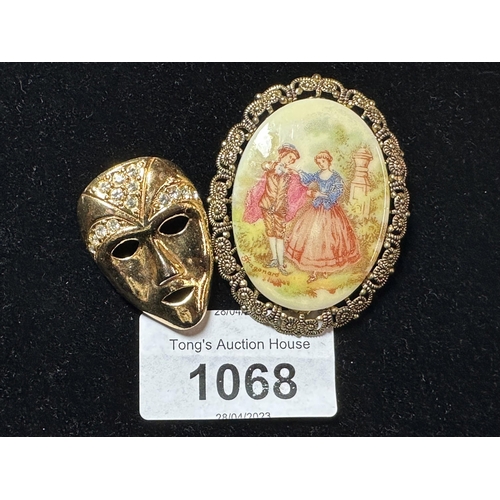1068 - Vintage Gold coloured German cameo style brooch and gold coloured Theatre mask pin brooch
