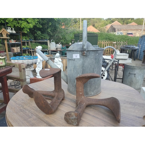37 - Galvanised watering can and 2 Antique Cast iron cobbler  3 footed shoe lasts