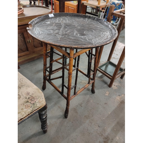 1738 - A lovely tropical style occasional table with a beautiful carved top