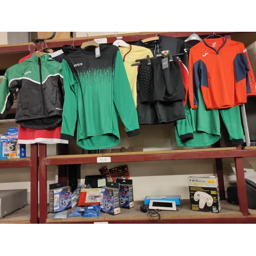 583 - Collection of sports clothing of various sizes including shorts, football shirts etc, some new with ... 