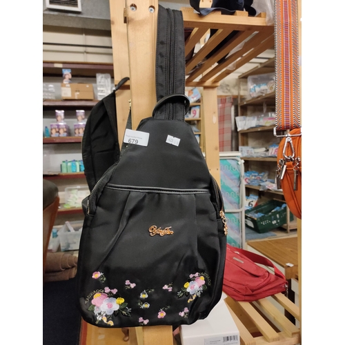 679 - An embroidered black backpack with many zipped pockets, can be converted into an over the shoulder b... 