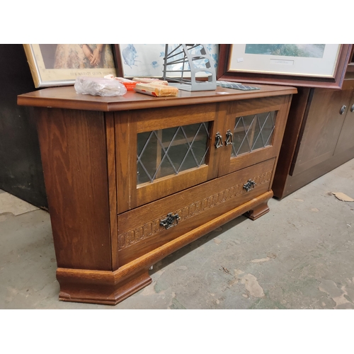 744 - Oak Corner television unit with drawer and two leaded glass doors.