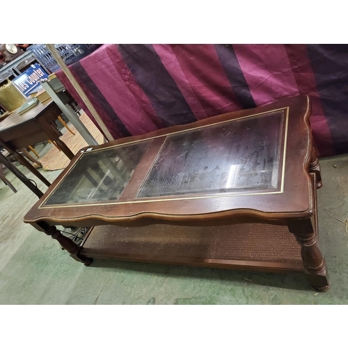 1209 - Glass topped coffee table, measures 120 x 52 x 43 cm.