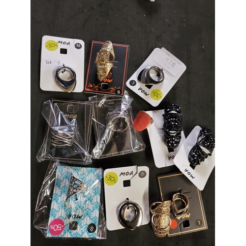 176 - A fabulous selection of costume rings in a variety of styles, all brand new with packaging