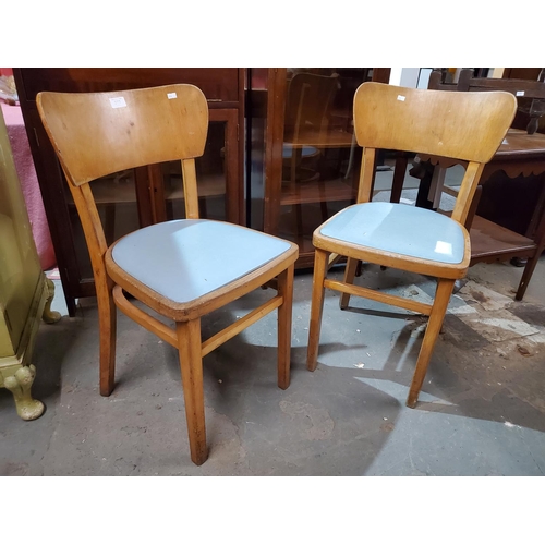 373 - A pair of 1970s kitchen chairs, upholstered with turquoise vinyl. 
Size in inches 31 (H) x 16 (D) x ... 